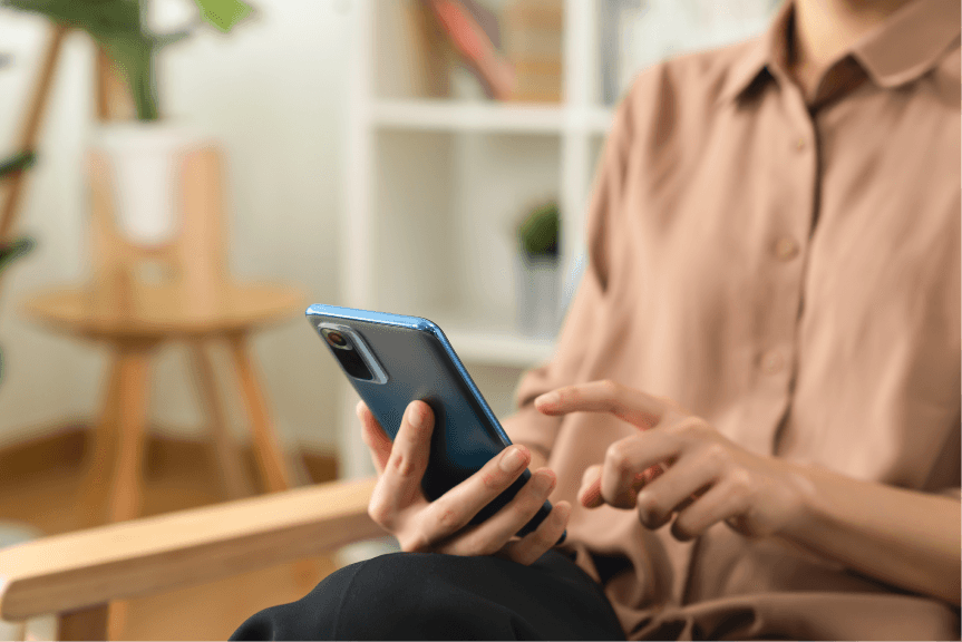 Person using smartphone in modern interior
